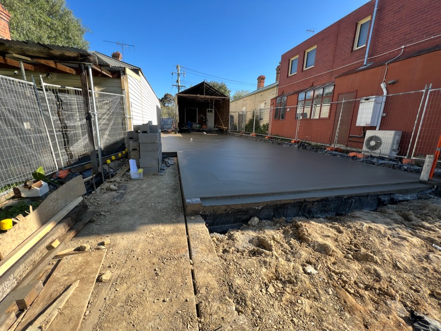 A new concrete slab for an extension between two brick buildings