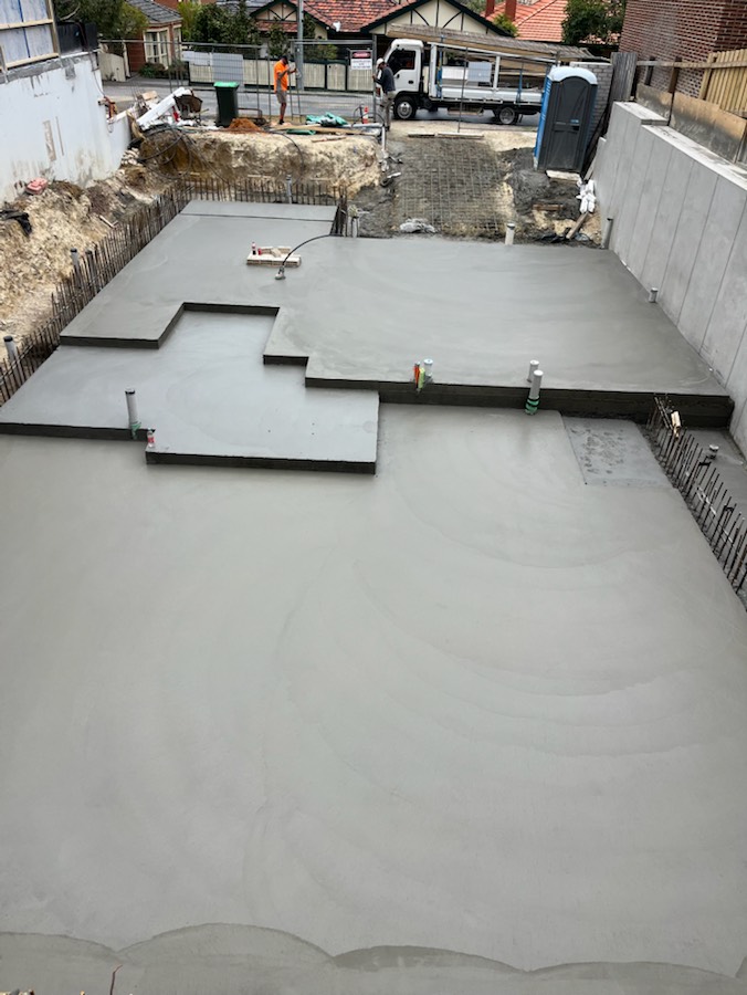 A concrete slab with set-downs beside concrete retaining walls, seen from above